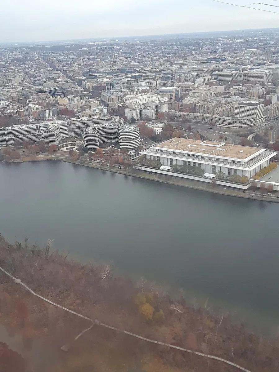 The John F. Kennedy Center for the Performing Arts, with the Watergate complex behind it, on the Potomac in Washington, in 2019.