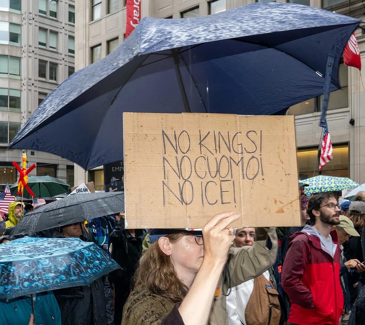 Demonstrators march in the rain during the first No Kings protest, in Manhattan, New York, in June 2025.